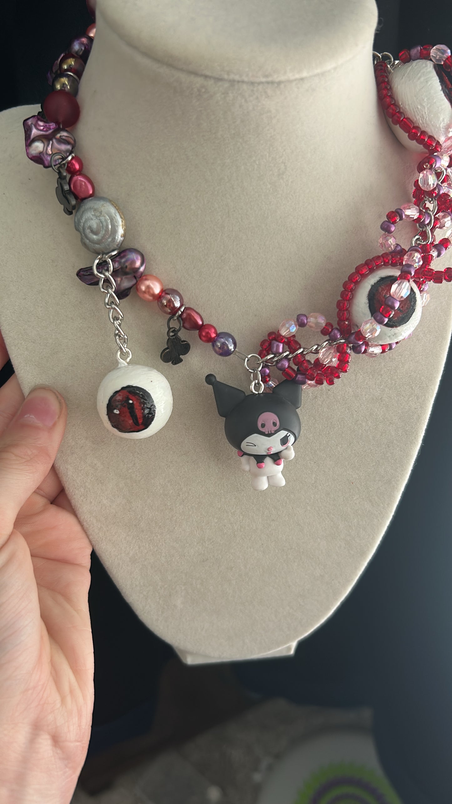 Necklace with charms on a mannequin bust